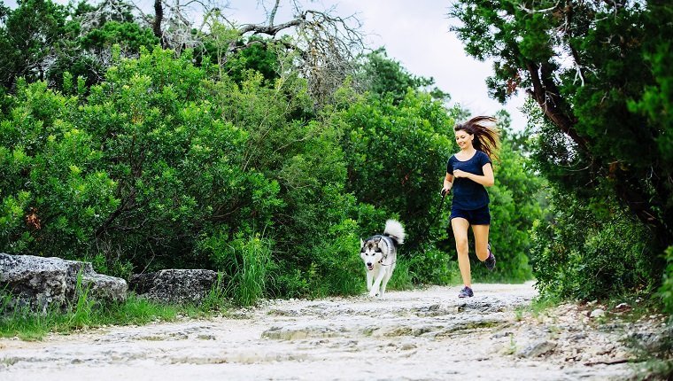 Caucasian woman jogging with dog