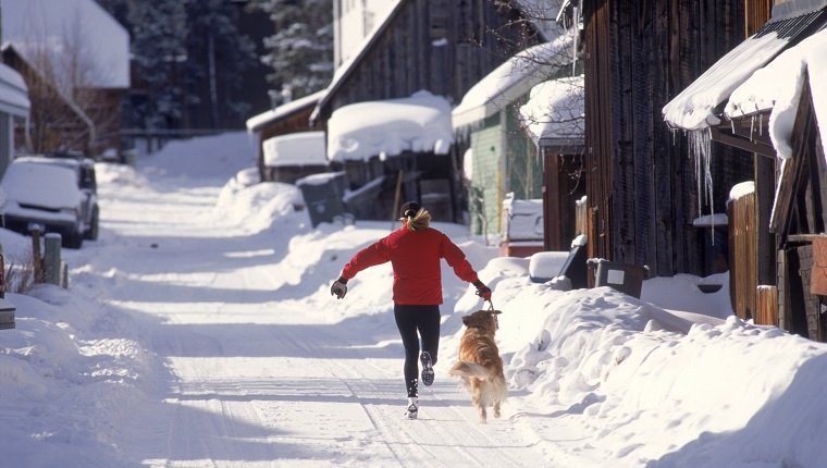 Woman running with dog, Breckenridge, CO